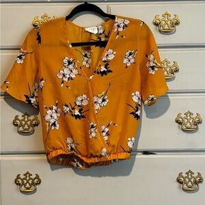 Sienna Sky size S mustard, black and white blouse.